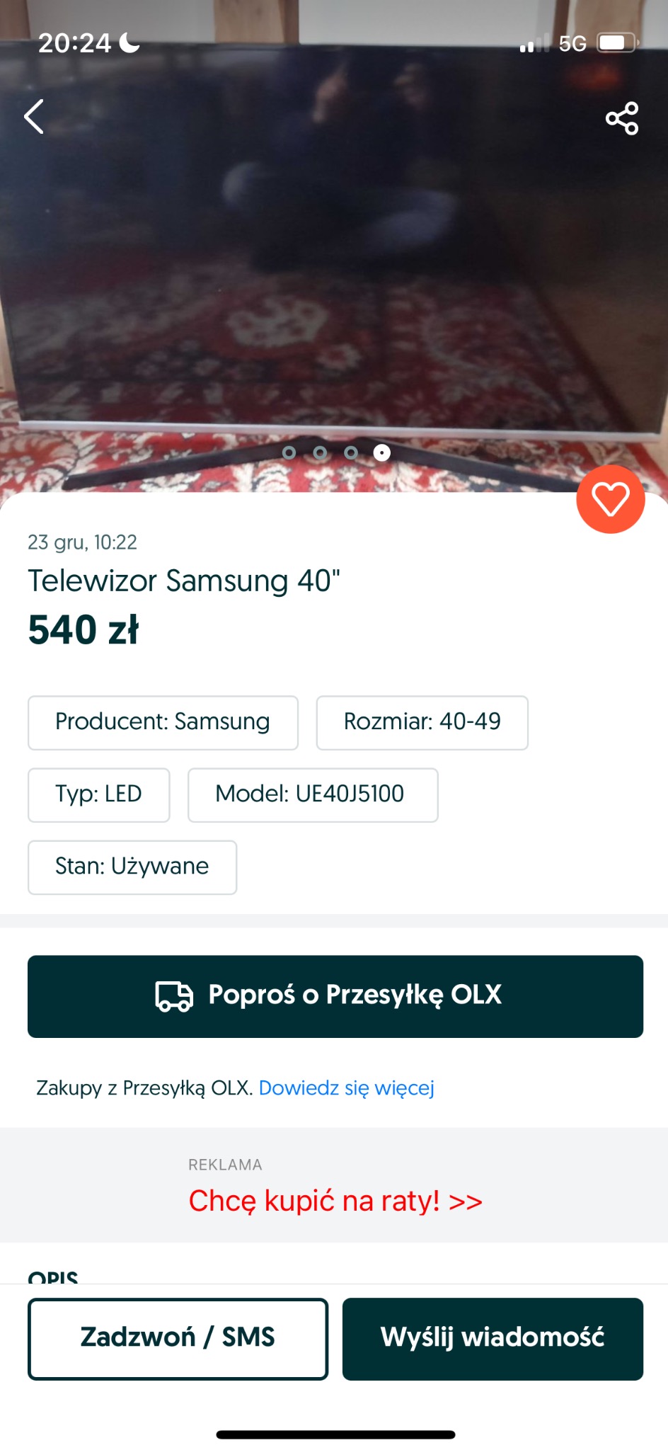 Używany telewizor Samsung 40 cali, model UE40J5100, typu LED, wystawiony na sprzedaż na tle wzorzystego dywanu.