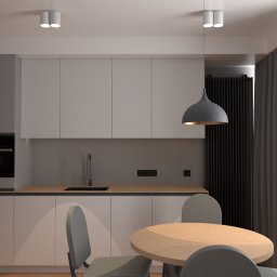 PAVEL TSYDZIK - Minimalistyczna kuchnia z okrągłym drewnianym stołem, szarymi krzesłami, białymi szafkami i wiszącą lampą z szarego betonu.