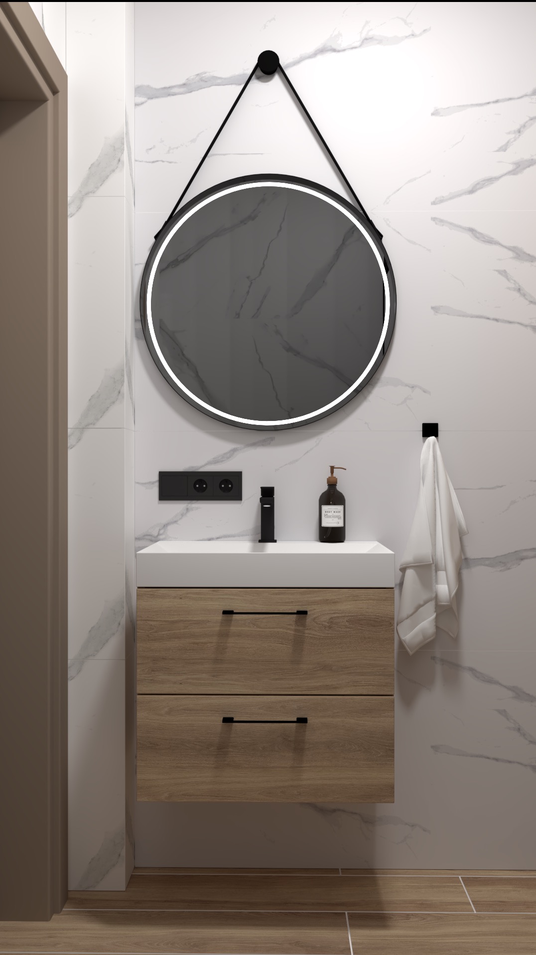 Nowoczesna łazienka z okrągłym lustrem LED zawieszonym na pasku, umywalką z szafką z dwoma szufladami o drewnianym wykończeniu, czarną armaturą i marmurowymi płytkami.