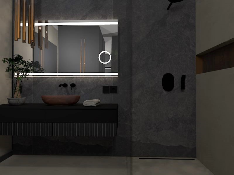 Nowoczesna łazienka z umywalką w kształcie misy, podświetlanym lustrem i ciemnymi płytkami imitującymi kamień, z minimalistycznymi czarnymi akcentami i dekoracyjną rośliną bonsai po lewej stronie.