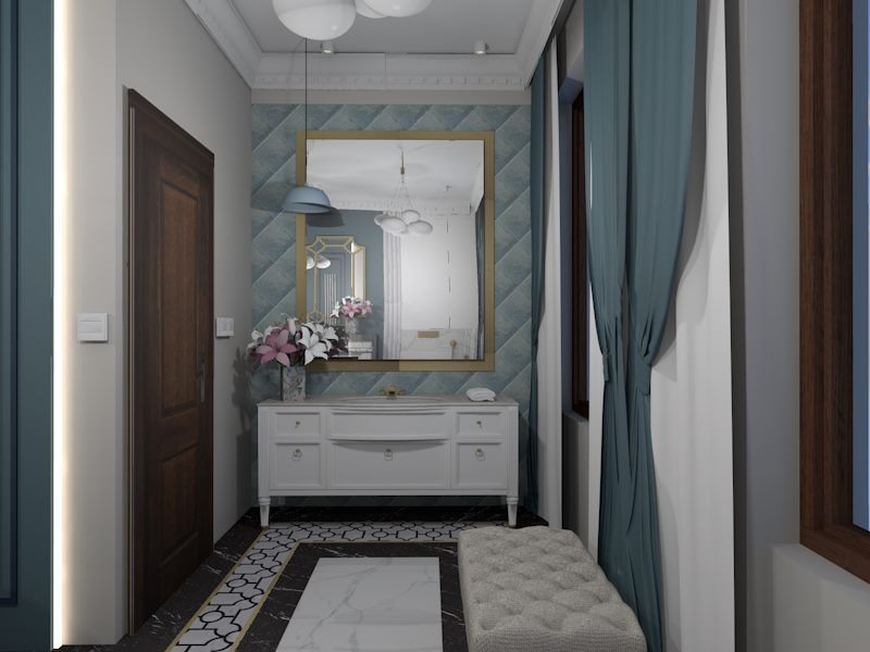 Aranżacja przedpokoju z białą komodą, lustrem w złotej ramie, kwiatami w wazonie, pufą i wzorzystą podłogą. Na ścianie błękitna tapeta w romby.