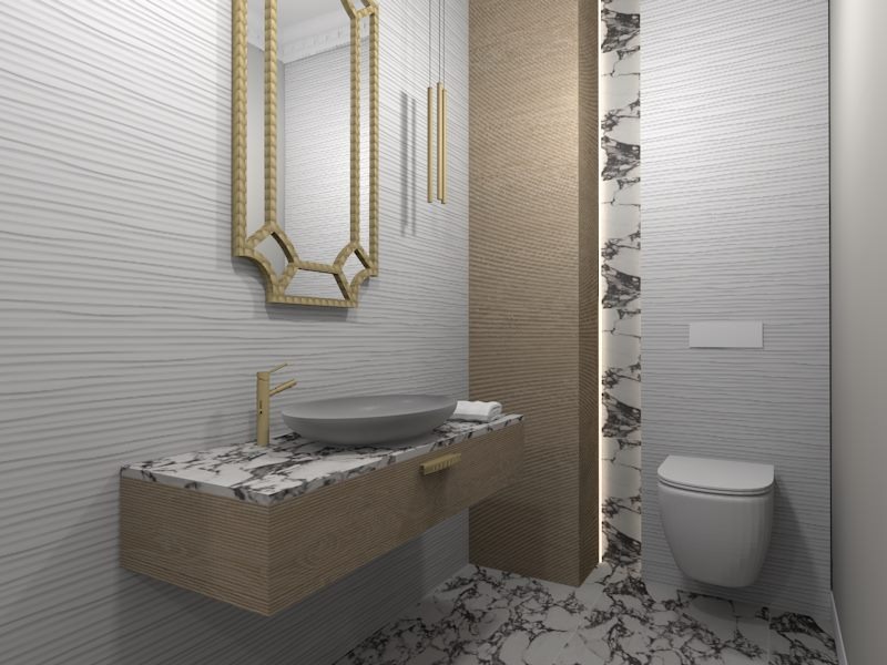 Nowoczesna łazienka z umywalką nablatową na marmurowym blacie, złota armatura, ozdobne lustro w złotej ramie i toaleta podwieszana na tle białych, falowanych płytek.