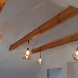 Szklane, kuliste lampy wiszące z żarówkami Edison, zamontowane na drewnianych belkach stropowych w nowoczesnym wnętrzu.