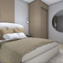 Agnieszka Krześniak - Neutralna sypialnia z łóżkiem z tapicerowanym zagłówkiem, okrągłym lustrem nad biurkiem z krzesłem na kółkach oraz rośliną w doniczce na stoliku nocnym, całość utrzymana w beżowej tonacji.