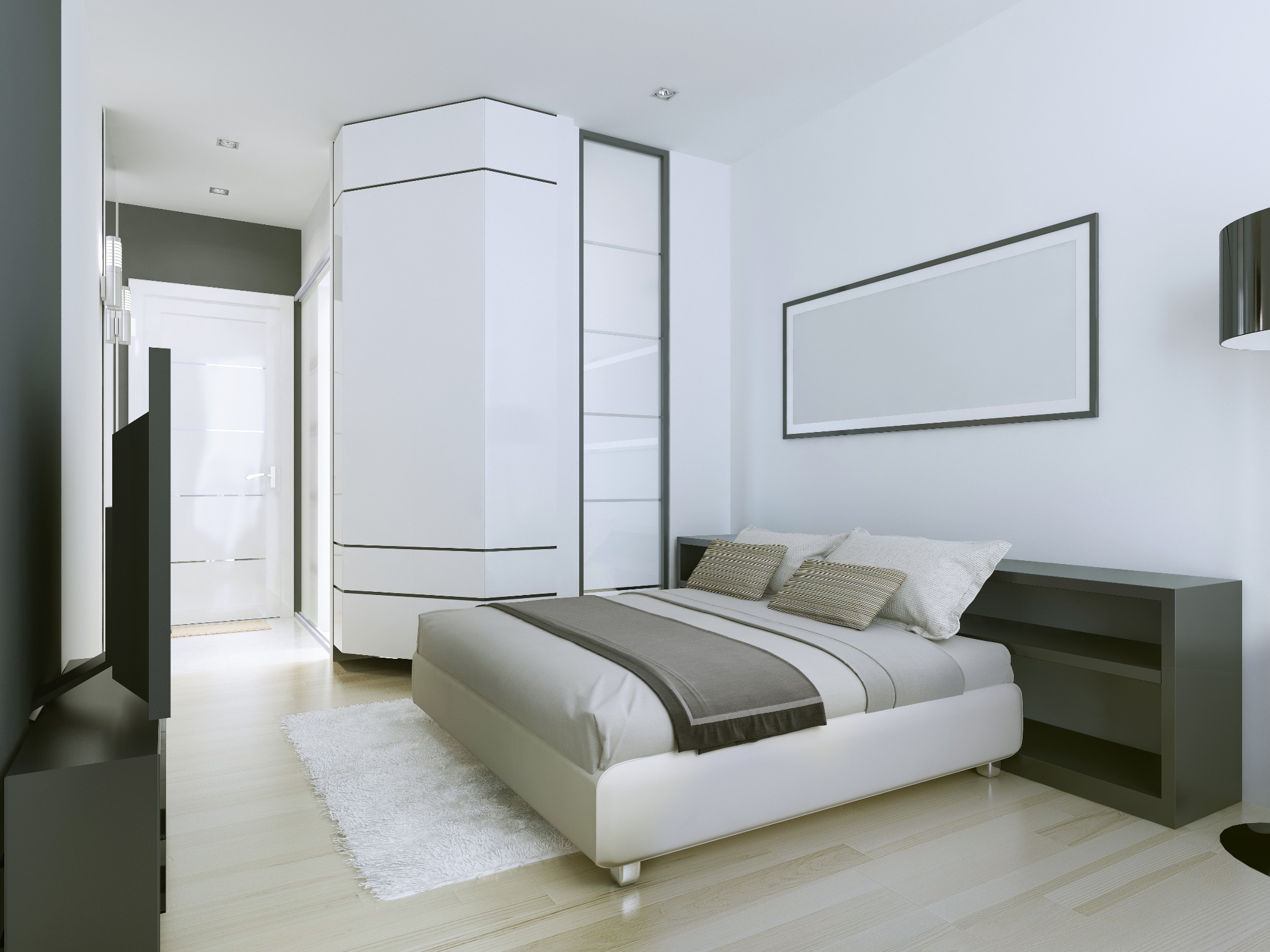 Nowoczesna sypialnia z białym łóżkiem, szarą narzutą i wzorzystymi poduszkami. Na ścianie wisi pusty, prostokątny obraz w czarnej ramie. W tle biała, futurystyczna szafa i drzwi.
