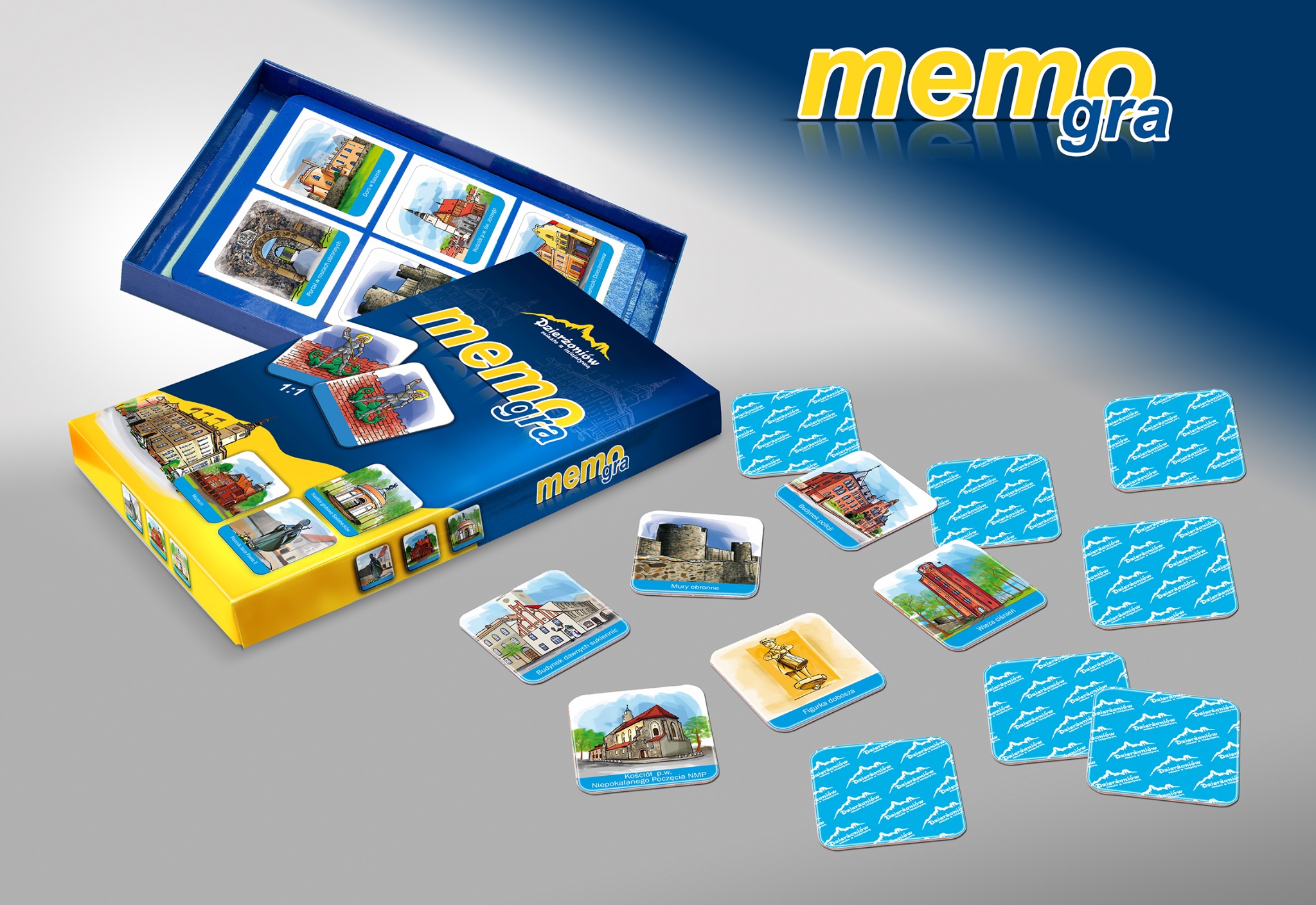 Gra memory z ilustracjami zabytków Dzierżoniowa: pudełko, otwarte pudełko z kartami w środku i rozłożone karty z budynkami, wieżami i pomnikami.