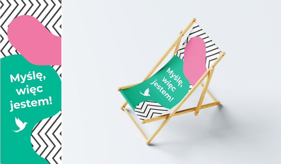 Leżak z nadrukiem: 'Myślę, więc jestem!', biały gołąb na zielonym tle, różowe i czarno-białe geometryczne wzory. Jasne drewno ramy, minimalistyczne tło.