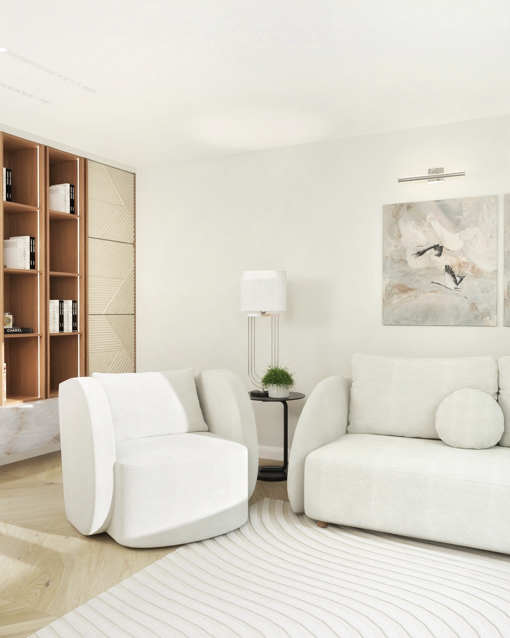 Jasne wnętrze: biały fotel i sofa na wzorzystym dywanie, regał z książkami, lampa i obraz z motywem ptaków tworzą spójną aranżację salonu.