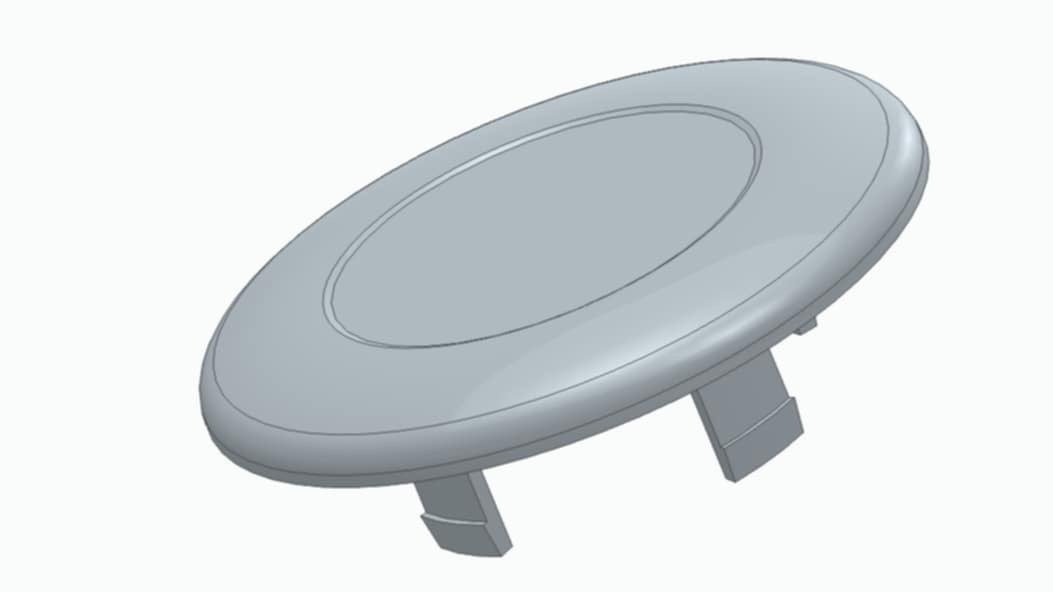 Szary, okrągły element z zaczepami, prawdopodobnie obudowa lub zaślepka, wykonana w technologii addytywnej, na białym tle. Widoczne linie podziału.