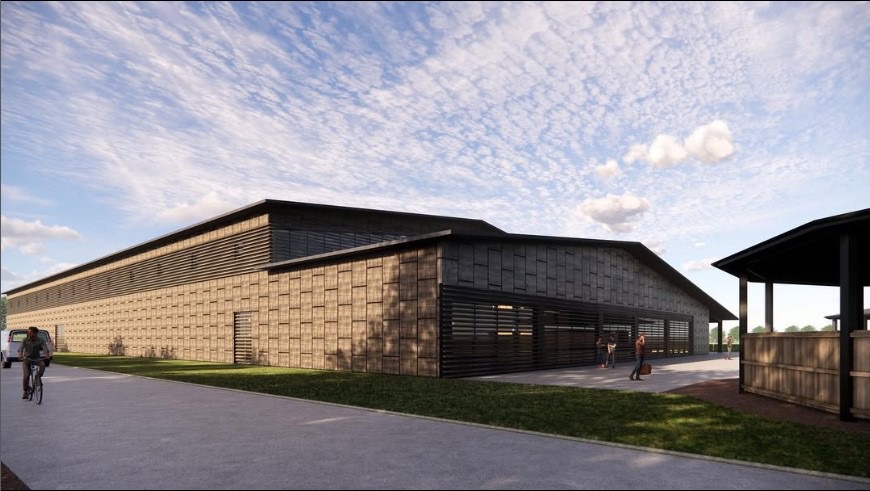 Wizualizacja zewnętrzna nowoczesnej hali z elewacją w odcieniach brązu i czerni, z widocznymi żaluzjami okiennymi i przesuwnymi bramami, zarys postaci ludzkich na tle budynku, rowerzysta na ścieżce...