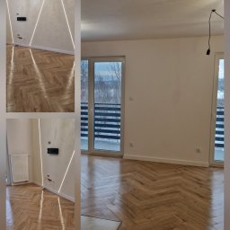 BIPI-BUD Bartłomiej Pazdro - Salon w Rzeszowie z parkietem ułożonym we wzór jodełki, oświetleniem LED wzdłuż ścian i widokiem na zimowy krajobraz z balkonu.