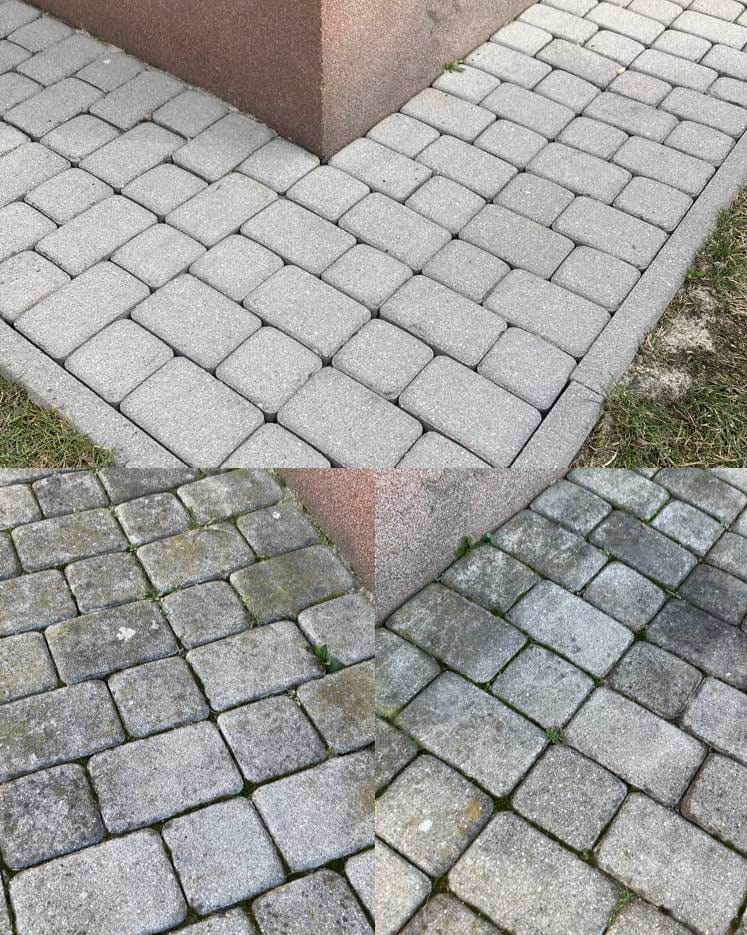 Szara kostka brukowa ułożona przy podstawie budynku z czerwonego kamienia. Część kostki jest czysta, a część pokryta mchem i zabrudzeniami.