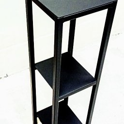 Fenix Michał Tupta, Rafał łapa Spòłka cywilna - Czarny, metalowy, trzypoziomowy stolik kawowy o minimalistycznym designie, stojący na białym tle.