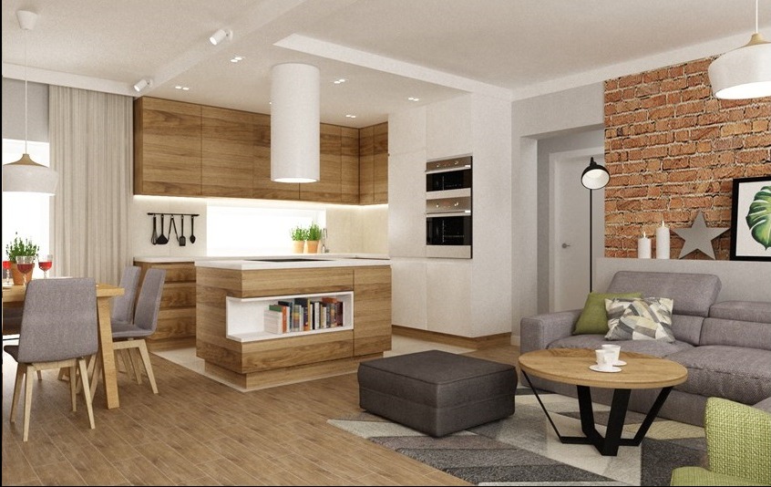 Nowoczesna kuchnia z drewnianymi frontami i wyspą z półkami na książki, połączona z salonem z ceglaną ścianą i szarą sofą. Minimalistyczny design z dbałością o detale.