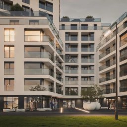 Bedroom Nieruchomości Świnoujście i Szczecin - Nowoczesny budynek apartamentowy z balkonami i szklanymi balustradami, oświetlony wieczornym światłem, z osobami w pobliżu wejścia i minimalistycznymi donicami.
