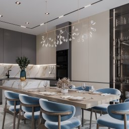 LOOMS Projektant Wnetrz - Nowoczesna jadalnia z blatem wyspowym z marmurowym wzorem, oświetlona designerską lampą z mlecznymi kloszami, krzesła tapicerowane błękitnym welurem.