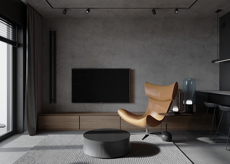 Minimalistyczny salon z szarą ścianą, skórzanym fotelem typu uszak w kolorze karmelowym, okrągłym stolikiem kawowym i podświetlaną podłogową lampą dekoracyjną