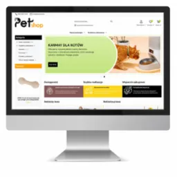 Ekran monitora wyświetlający stronę internetową sklepu zoologicznego z ofertą karmy dla kotów, pomarańczowy kot je karmę z automatycznego podajnika.