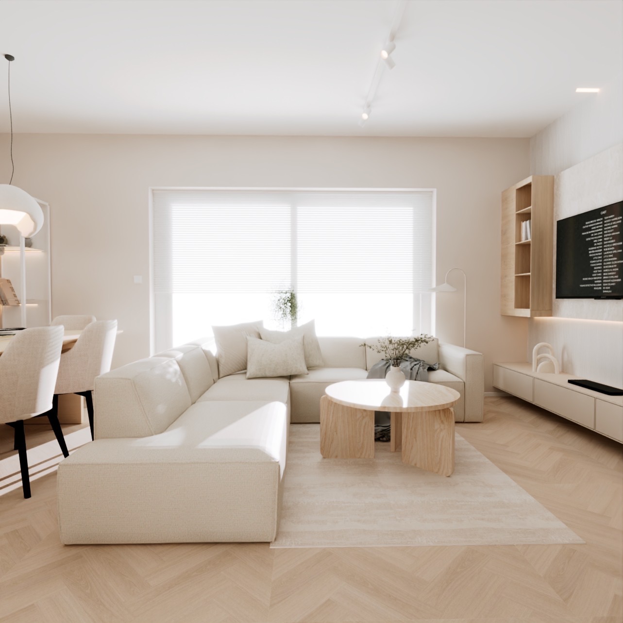 Jasne, przestronne wnętrze salonu z narożną sofą w odcieniach beżu, okrągłym drewnianym stolikiem kawowym i telewizorem na ścianie, minimalistyczny design, parkiet ułożony w jodełkę.