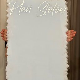 LIBER4CARS GRZEGORZ LIBER - Akrylowa tablica z napisem 'Plan Stołów' w ozdobnej czcionce, trzymana przez osobę. Dekoracja ślubna z unikalnym, nieregularnym obrysem.