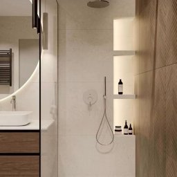 Krzysztof Danowski - Nowoczesna łazienka z kabiną typu walk-in, umywalką na szafce z drewnianymi frontami i oświetleniem LED. Minimalistyczny design z akcentem na naturalne materiały.