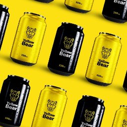 JAID - Żółto-czarne puszki z logo geometrycznego niedźwiedzia na żółtym tle. Prezentacja produktu 'Yellow Bear' z kroplami wody, podkreślająca świeżość napoju.