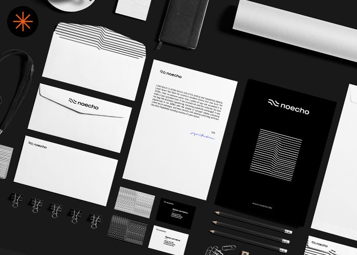 Komplet materiałów firmowych z logo 'noecha' na czarnym tle: koperty, wizytówki, papier firmowy, notatnik, ołówki. Minimalistyczny design w czerni i bieli.