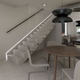 The Plan sp. z o.o. - Nowoczesne wnętrze z marmurowymi schodami, podświetleniem LED, okrągłym stołem i krzesłami. Minimalistyczny design z widokiem na salon i ogród.