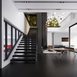 INDYWIDUALNE PROJEKTY DOMÓW OD 6000 PLN BRUTTO - STUDIO DREAMSPACE com pl - Nowoczesne wnętrze domu z czarnymi schodami, zieloną ścianą i czerwonym sportowym autem w garażu widocznym przez okno. Minimalistyczny design i eleganckie wykończenie.