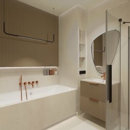 INTERIOR DESIGN Julia Jarząbkiewicz - Nowoczesna łazienka w beżach z wanną, umywalką z szafką i kabiną prysznicową; akcenty w kolorze miedzi, oświetlenie LED i dekoracyjna ściana z pionowymi żłobieniami.