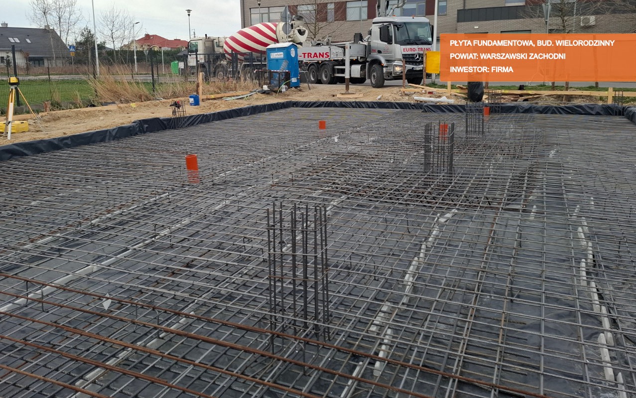 Zbrojenie płyty fundamentowej przygotowane do zalania betonem w Ożarowie Mazowieckim, widoczny betonowóz i poziomica laserowa.
