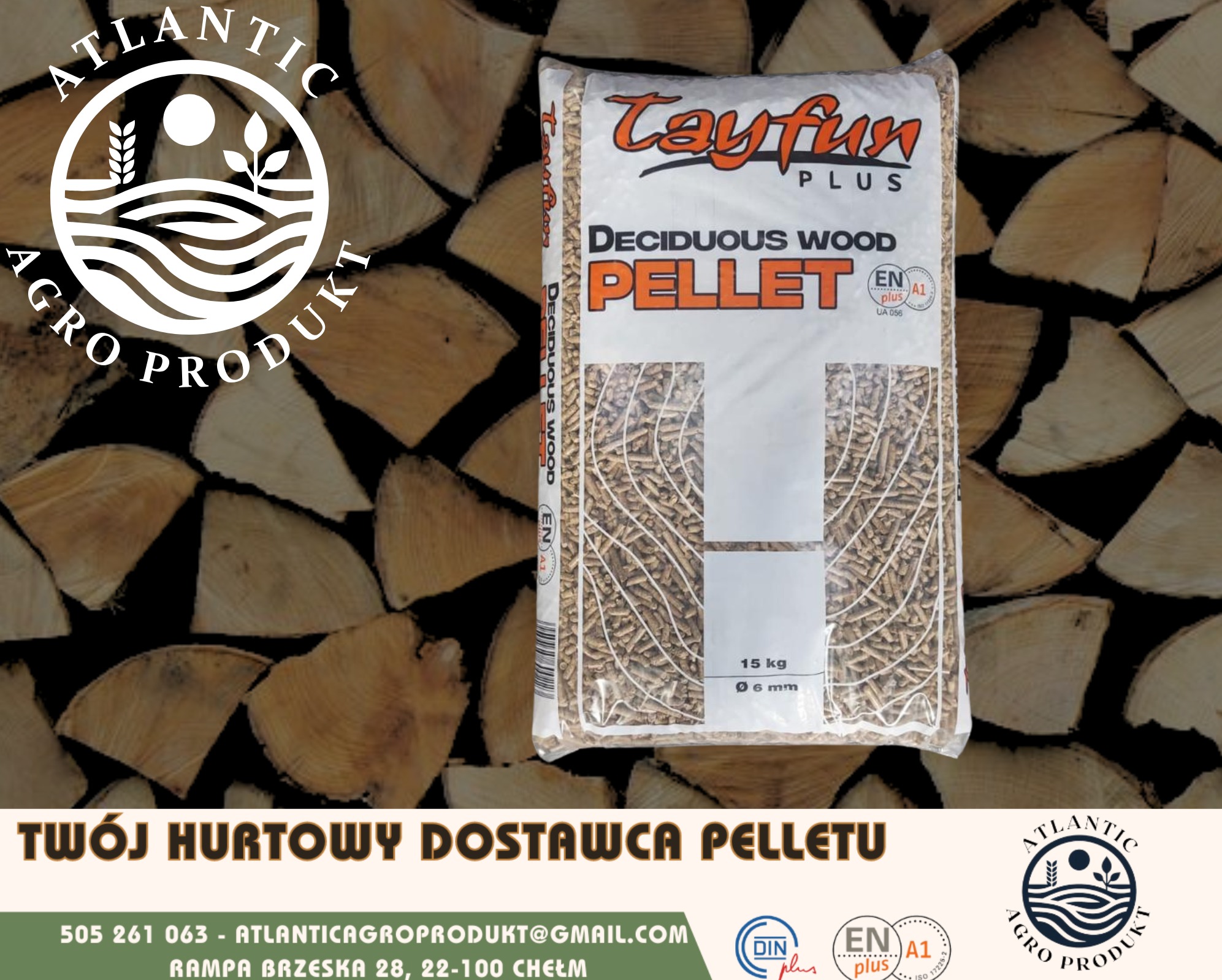 Worek pelletu drzewnego liściastego 'Tayfun Plus' 15 kg, na tle ułożonego drewna. Widoczne logo Atlantic Agro Produkt.