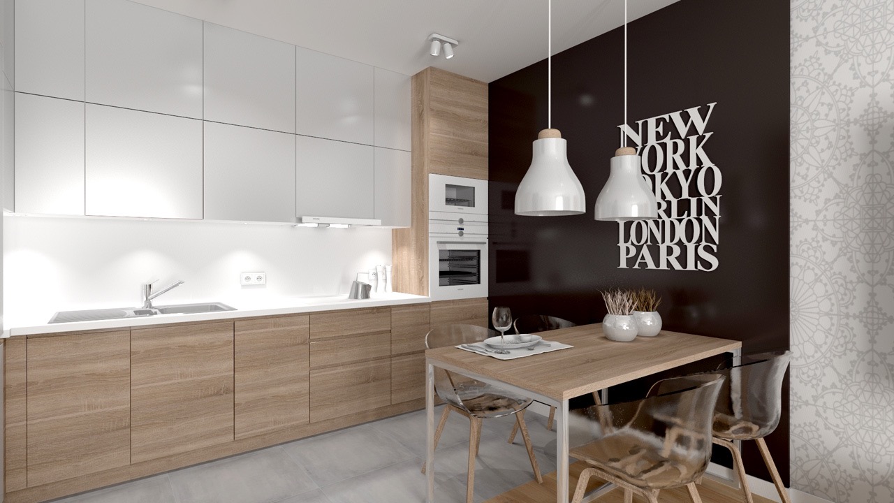 Nowoczesna kuchnia z drewnianymi szafkami i białymi frontami, oświetlona wiszącymi lampami. Na ścianie dekoracja z nazwami miast.