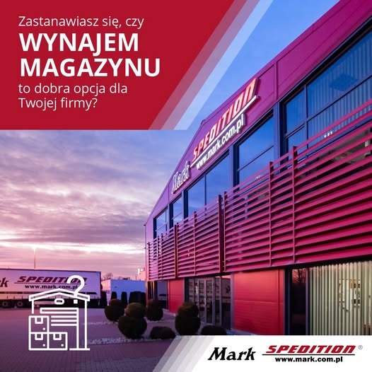 Budynek magazynowy firmy spedycyjnej Mark z logo i grafiką informującą o wynajmie magazynu. Na parkingu stoi ciężarówka z logo firmy na naczepie.