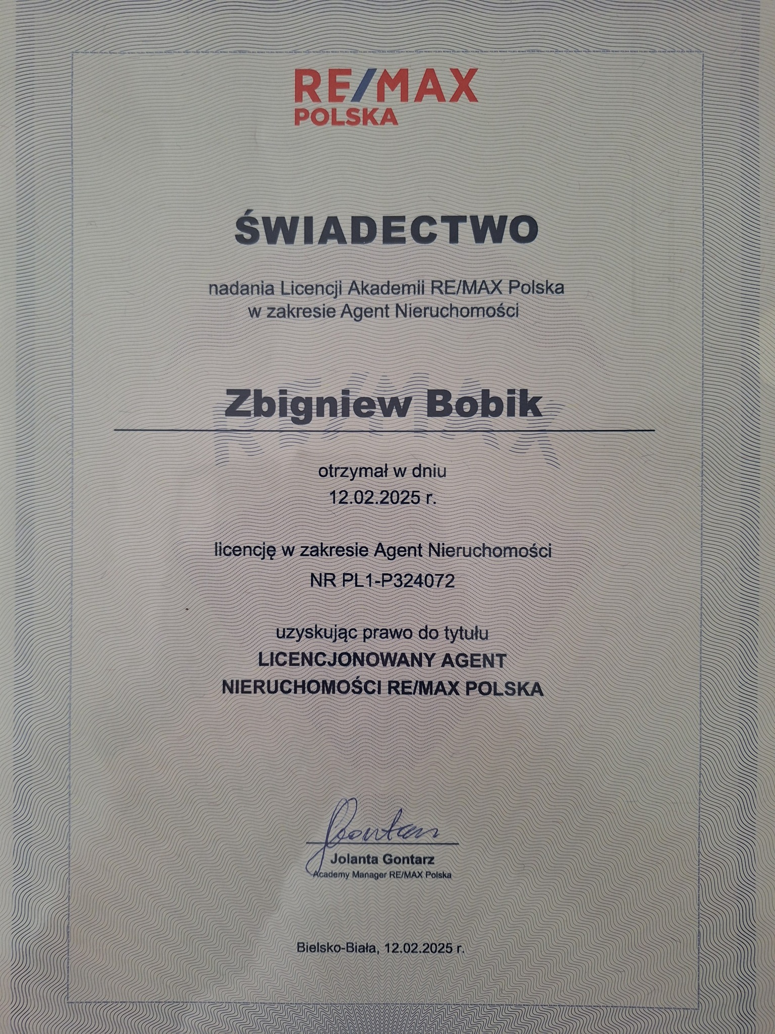 Świadectwo licencji agenta nieruchomości RE/MAX Polska dla Zbigniewa Bobika, wydane w Bielsku-Białej 12.02.2025 r. z podpisem Jolanty Gontarz.
