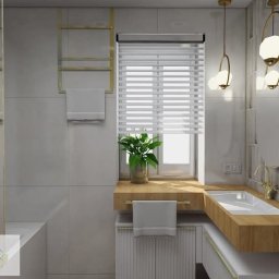 J.W.B Home Design - Nowoczesna łazienka z drewnianym blatem, okrągłym lustrem i wiszącymi lampami. Minimalistyczny design z akcentami złota i rośliną w doniczce na parapecie.