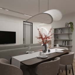 Preludium Design Patrycja Gawryszewska - Nowoczesna aranżacja salonu z jadalnią: stół z nakryciem, szara sofa, designerskie lampy i regał z dekoracjami. Minimalistyczny wystrój w jasnych barwach.