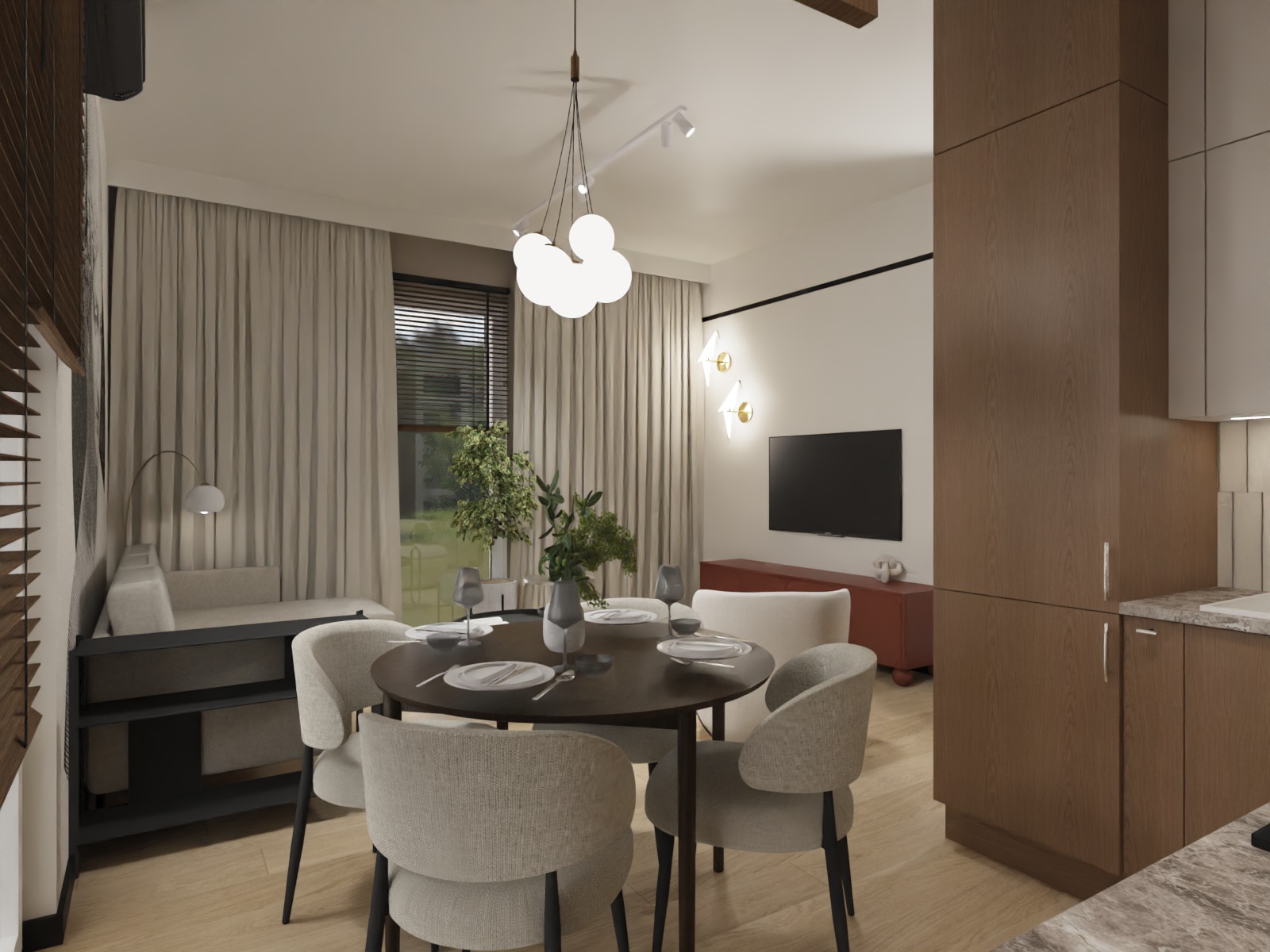 Nowoczesne wnętrze: okrągły stół jadalny z nakryciem, krzesła tapicerowane, minimalistyczna lampa wisząca, telewizor na ścianie i zabudowa kuchenna w tle.