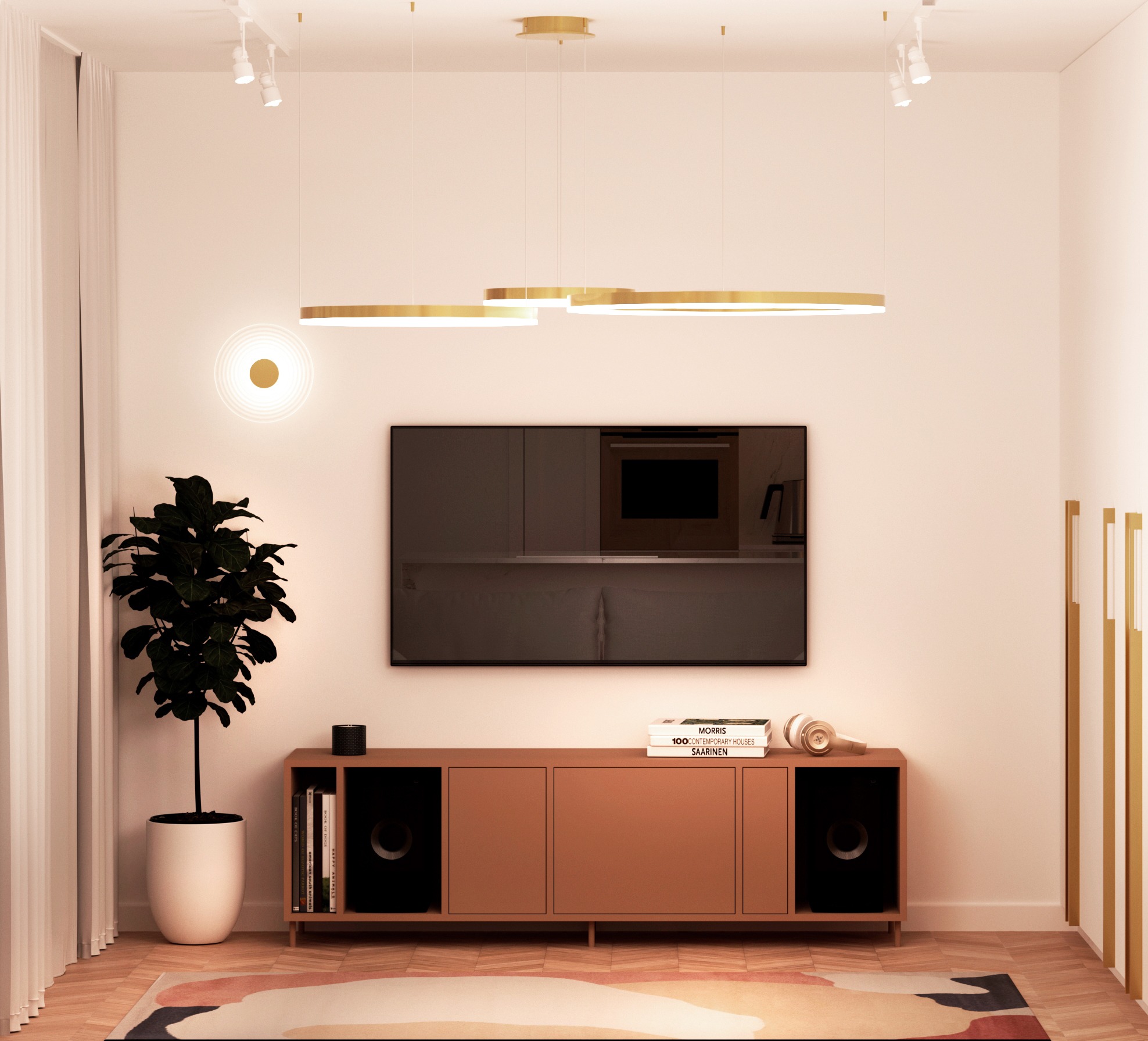 Salon z telewizorem, brązową szafką RTV, rośliną w białej donicy i okrągłą lampą. Nad szafką książki i słuchawki, na ścianie ciemne fronty szafek kuchennych.