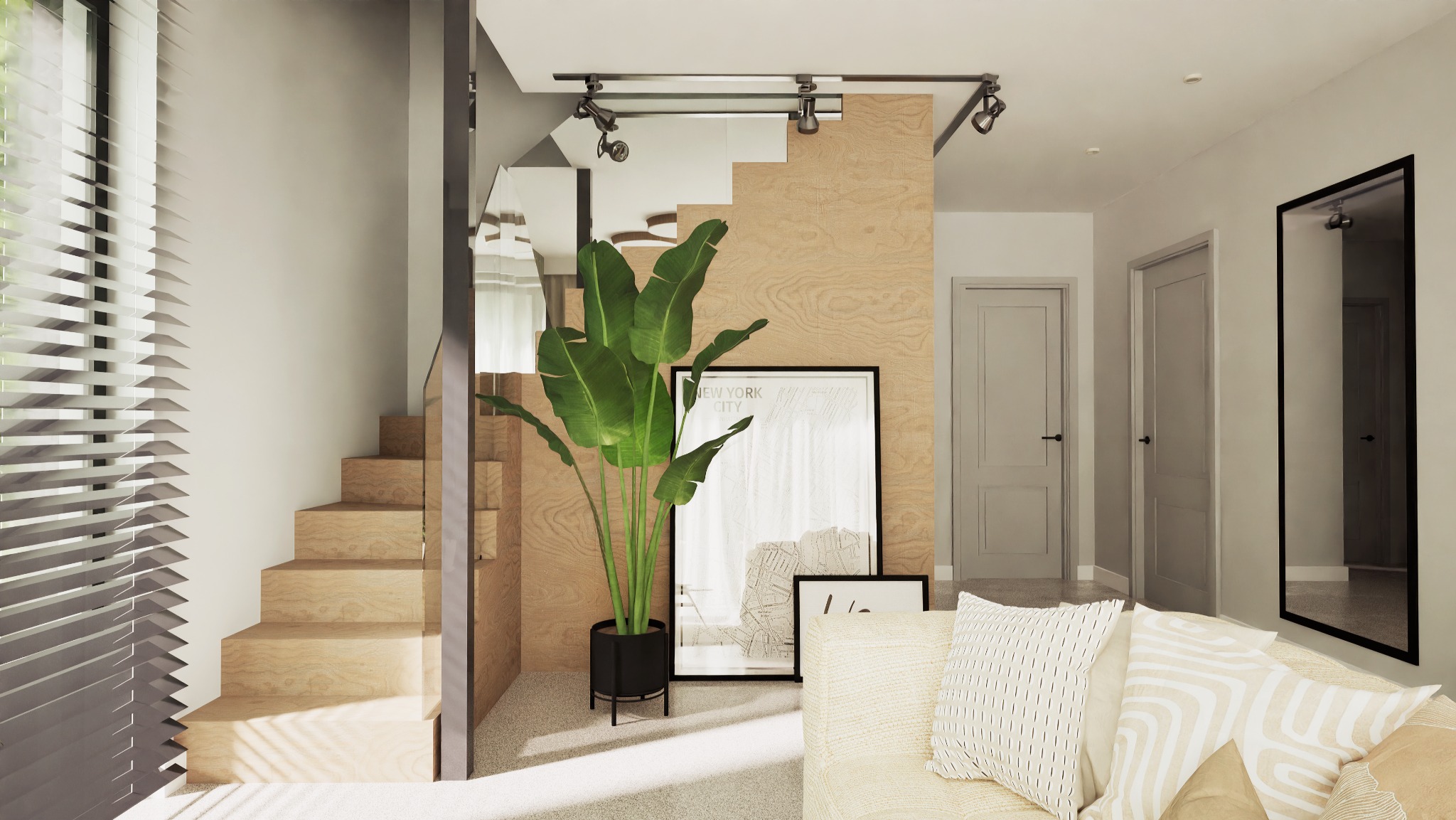 Jasne wnętrze z drewnianymi schodami, rośliną w czarnej donicy i minimalistycznymi plakatami. Widoczne oświetlenie punktowe i fragment sofy z poduszkami.
