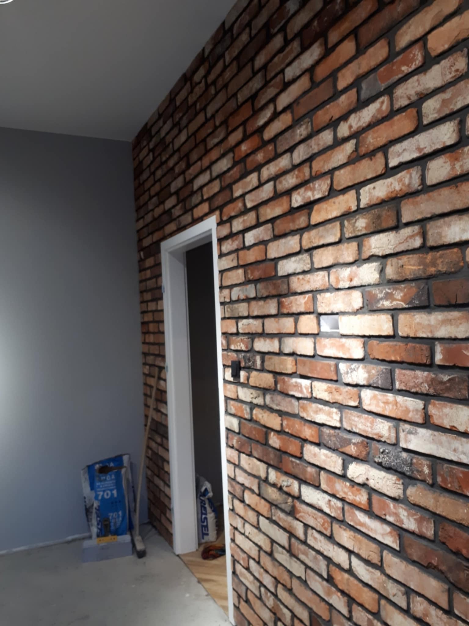 Ozdobna cegła na jednej ścianie, reszta jest szpachlowana i malowana