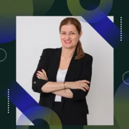 Uśmiechnięta kobieta w czarnej marynarce, z założonymi rękami, na tle nowoczesnej grafiki. Profesjonalny portret pośrednika nieruchomości.