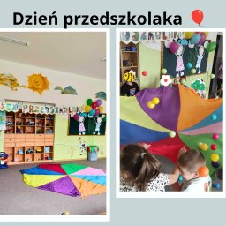 Agnieszka Bielak - Sala przedszkolna udekorowana na Dzień Przedszkolaka: kolorowe dekoracje, rysunki na ścianach, dzieci bawiące się pod wielobarwną chustą animacyjną z piłeczkami.