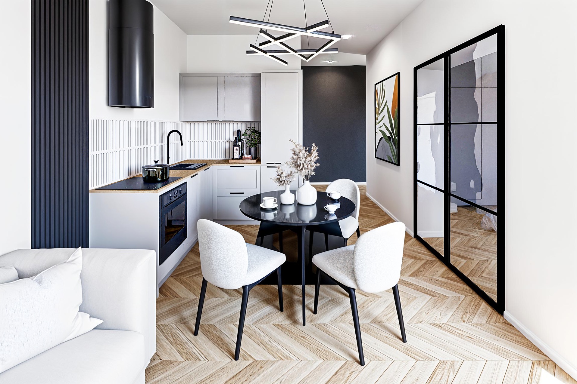 Nowoczesna aranżacja wnętrza: kuchnia z jadalnią w bieli, szarości i czerni. Parkiet w jodełkę, czarne drzwi szklane, minimalistyczna lampa. Roślina w ramie.