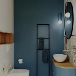 Stylowa łazienka z niebieską ścianą, wzorzystą podłogą i owalnym lustrem. Umywalka nablatowa i czarny regał na ręczniki dodają elegancji.