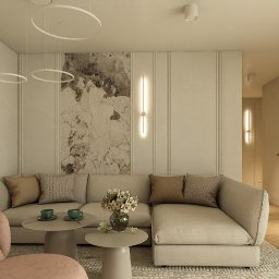 Katarzyna Wilkosińska - Elegancki salon z beżową sofą narożną, różowym fotelem i pufem. Ściana z marmurowym panelem i pionowymi listwami, okrągłe lampy wiszące. Jasne wnętrze z parkietem w jodełkę.