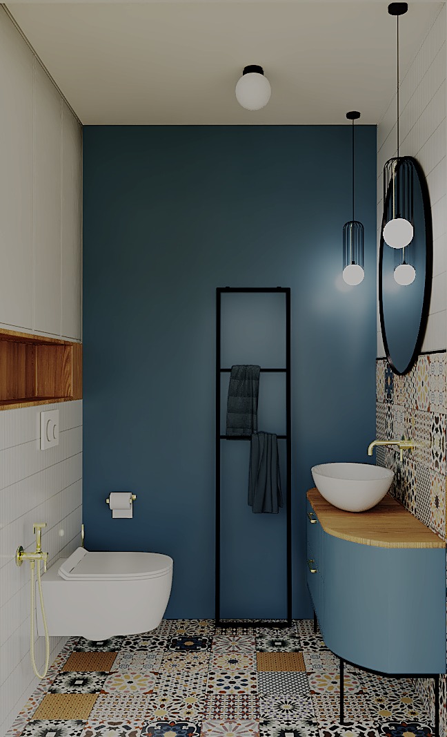 Stylowa łazienka z niebieską ścianą, wzorzystą podłogą i owalnym lustrem. Umywalka nablatowa i czarny regał na ręczniki dodają elegancji.
