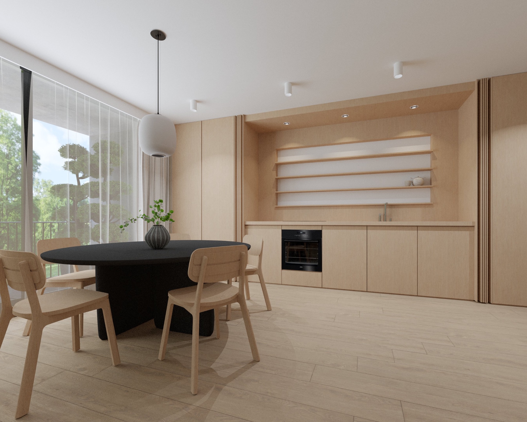Jasna, minimalistyczna jadalnia z okrągłym, czarnym stołem, drewnianymi krzesłami i zabudową kuchenną w odcieniach beżu. Duże okno z widokiem na zieleń.