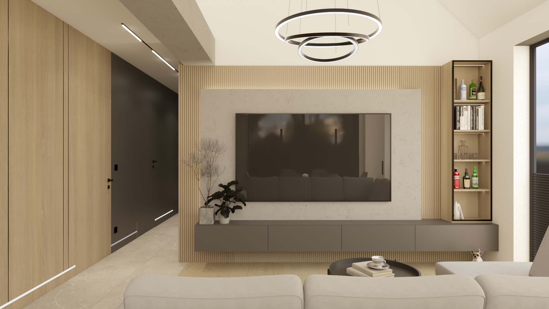 Nowoczesny salon z drewnianą zabudową, szarą szafką RTV i regałem. Okrągła lampa sufitowa i minimalistyczne oświetlenie liniowe. W tle widoczny fragment sofy.