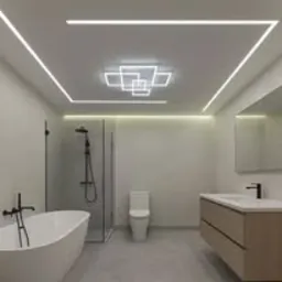 Nowoczesna łazienka z podświetlanym sufitem. Białe ściany, wanna, toaleta, umywalka z szafką. Geometryczne oświetlenie sufitowe LED.